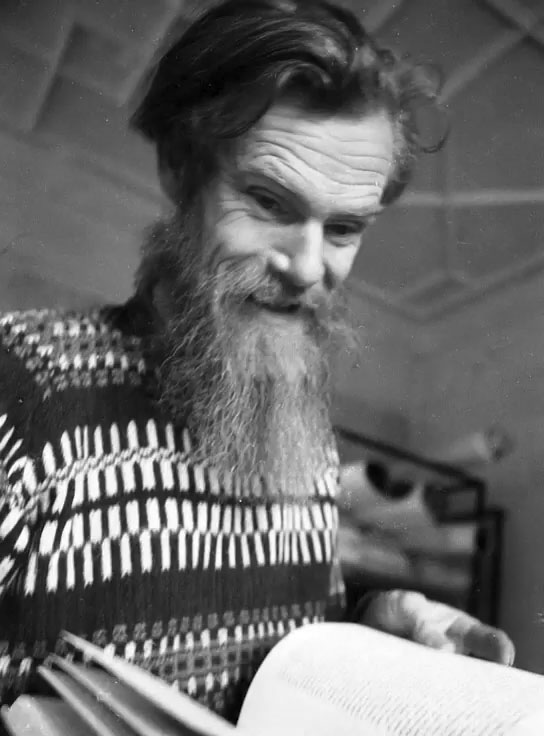 Lionel Miskin painting on an open book